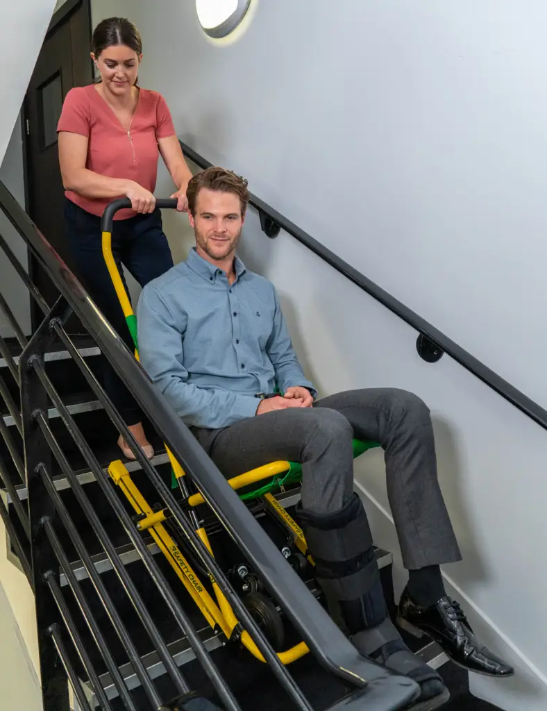Instructor demonstrating evacuation chair techniques during Train the Trainer course