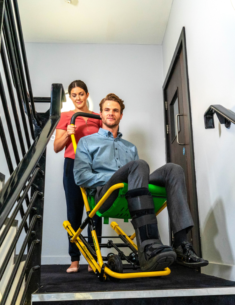 Instructor demonstrating evacuation chair usage during training session
